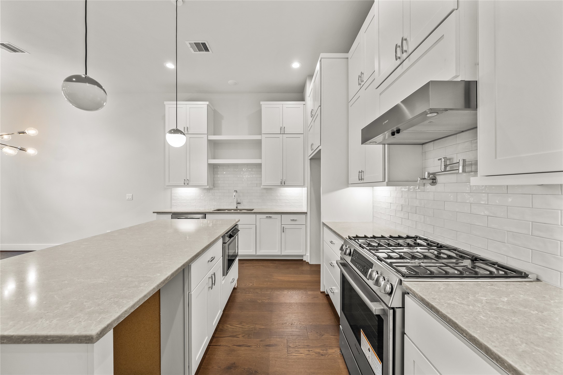 1705 Bologna Lane Houston, TX 77055 - Photo 6 of 43 a white kitchen with stainless steel appliances granite countertop a stove and a sink