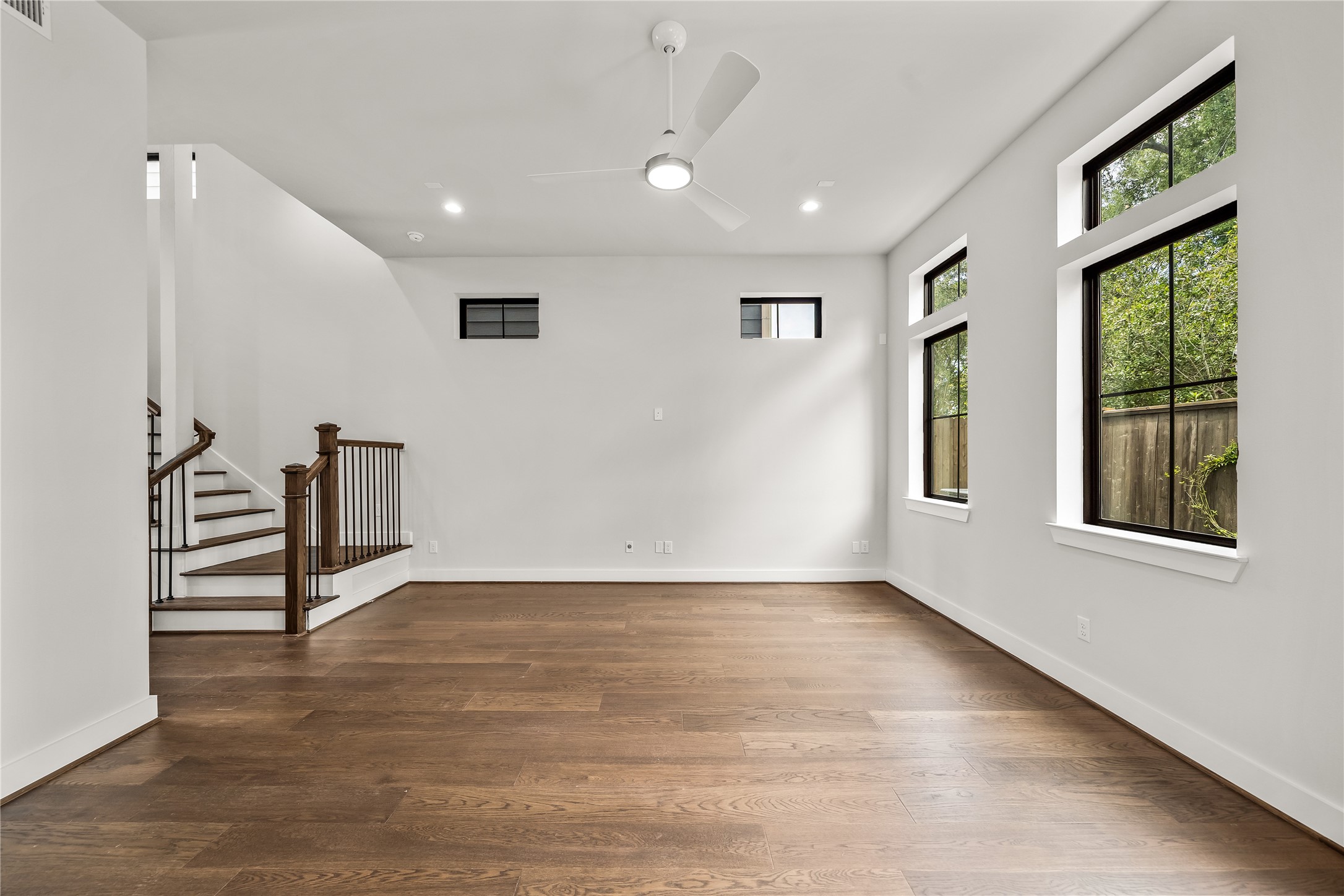 1705 Bologna Lane Houston, TX 77055 - Photo 9 of 43 a view of an empty room with wooden floor and a window