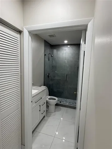 a bathroom with a toilet and a shower