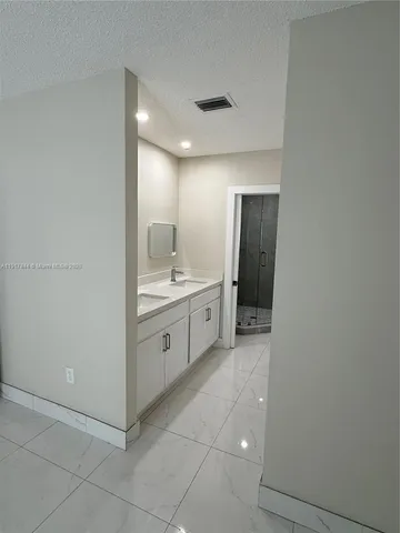a view of a hallway to closet and utility room