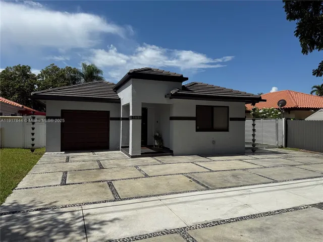 a view of house with entertaining space in front of it