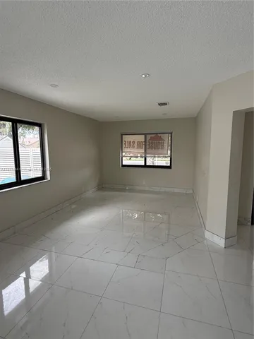 a view of an empty room with windows