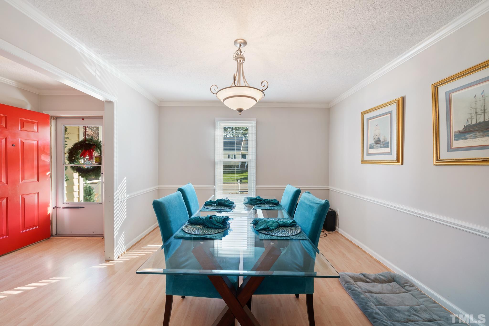 8205 Bellingham Circle Raleigh, NC 27615 - Photo 12 of 16 a view of a dining room with furniture window and wooden floor