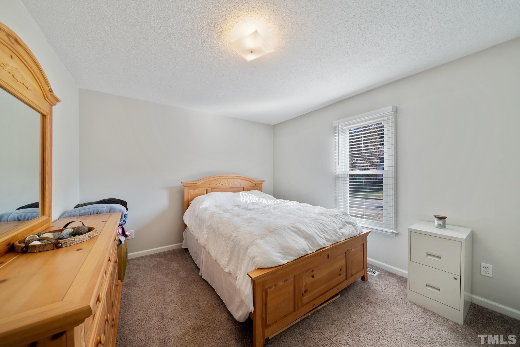 8205 Bellingham Circle Raleigh, NC 27615 - Photo 13 of 16 a bed room with a bed and a window