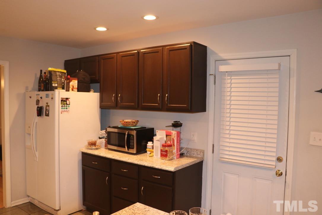 8205 Bellingham Circle Raleigh, NC 27615 - Photo 6 of 16 a kitchen with stainless steel appliances a refrigerator and a sink