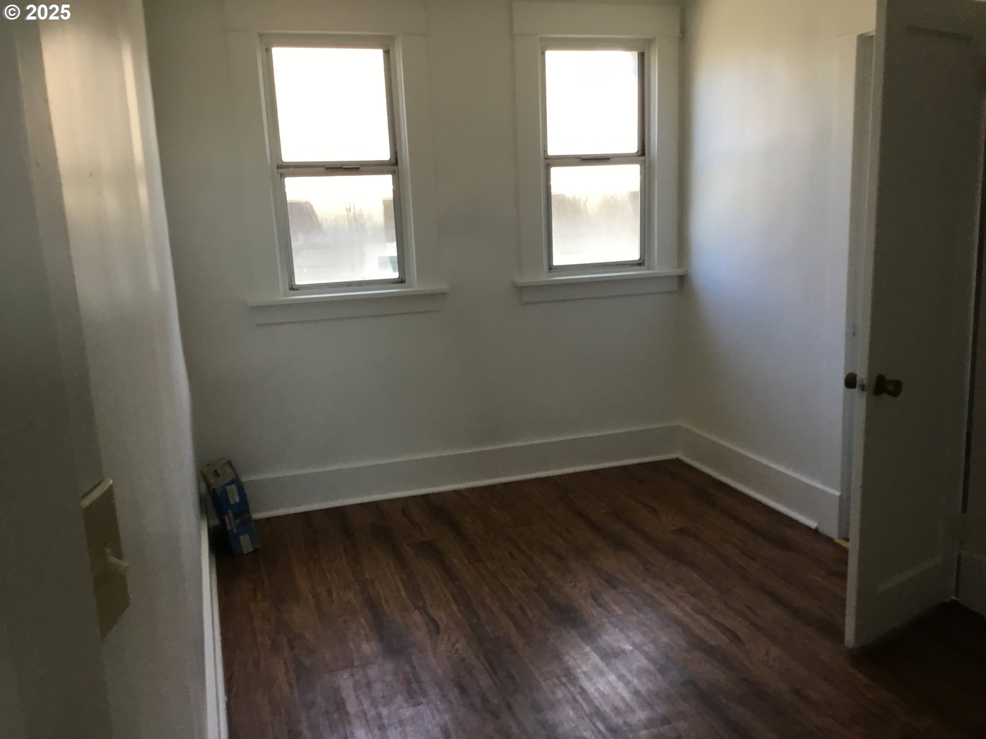 2517 Liberty Street North Bend, OR 97459 - Photo 24 of 42 an empty room with wooden floor and windows