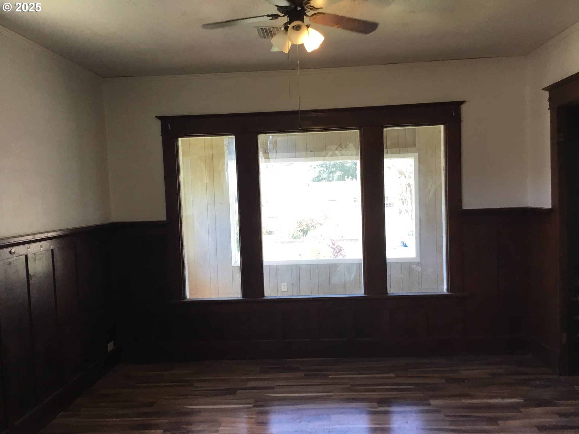2517 Liberty Street North Bend, OR 97459 - Photo 4 of 42 a view of an empty room with wooden floor and a window
