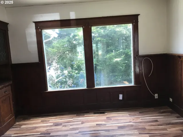 a view of a floor to ceiling window and hardwood floor