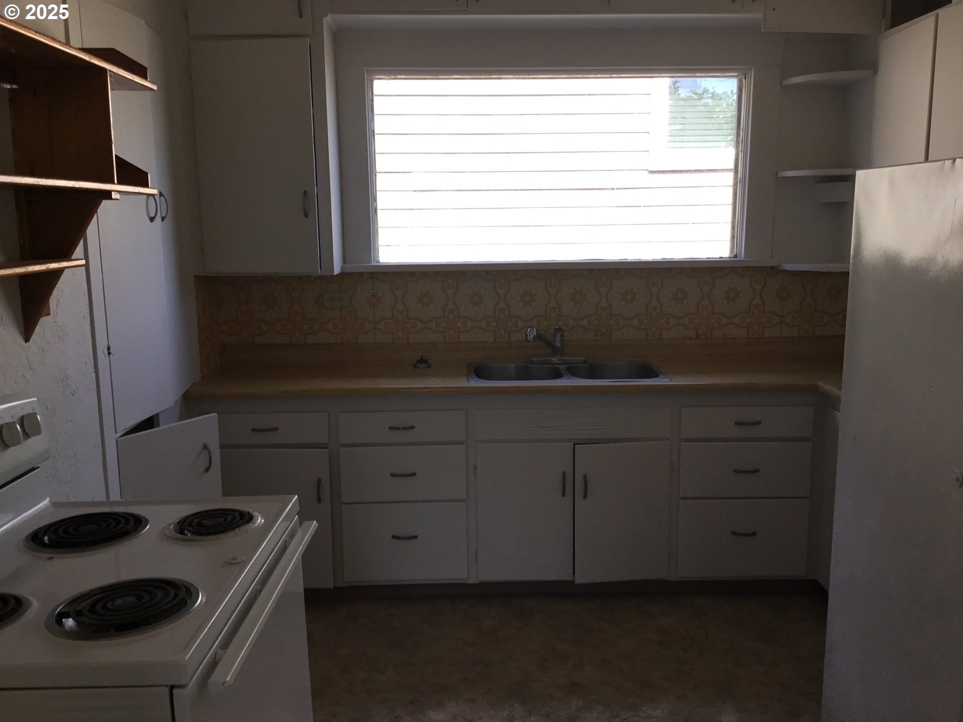 2517 Liberty Street North Bend, OR 97459 - Photo 8 of 42 a kitchen with a sink a stove and cabinets