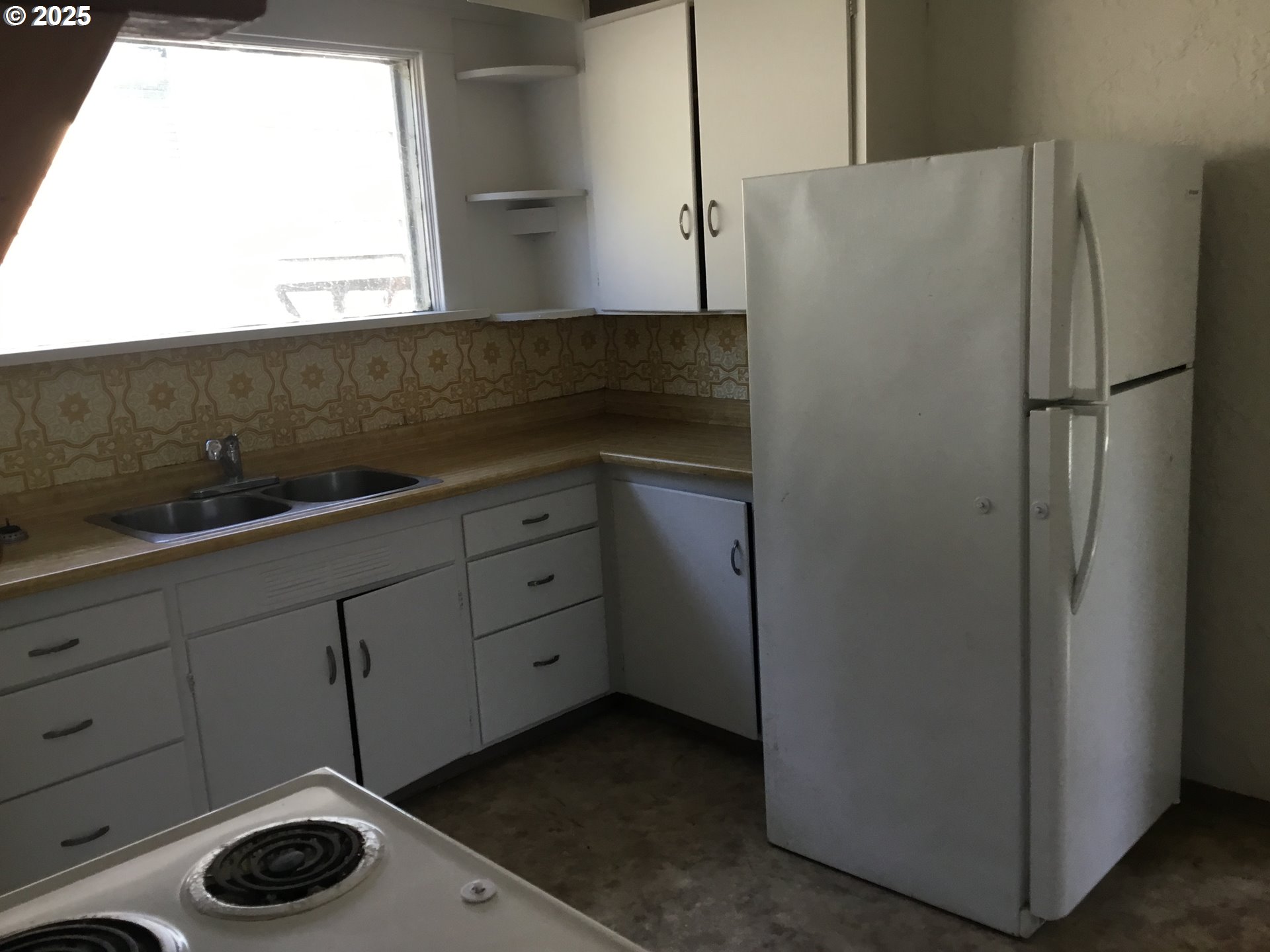 2517 Liberty Street North Bend, OR 97459 - Photo 9 of 42 a kitchen with a refrigerator and a window