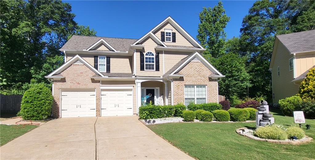 1123 Silverbrook Drive Powder Springs, GA 30127 - Photo 1 of 1 a front view of a house with a yard and potted plants