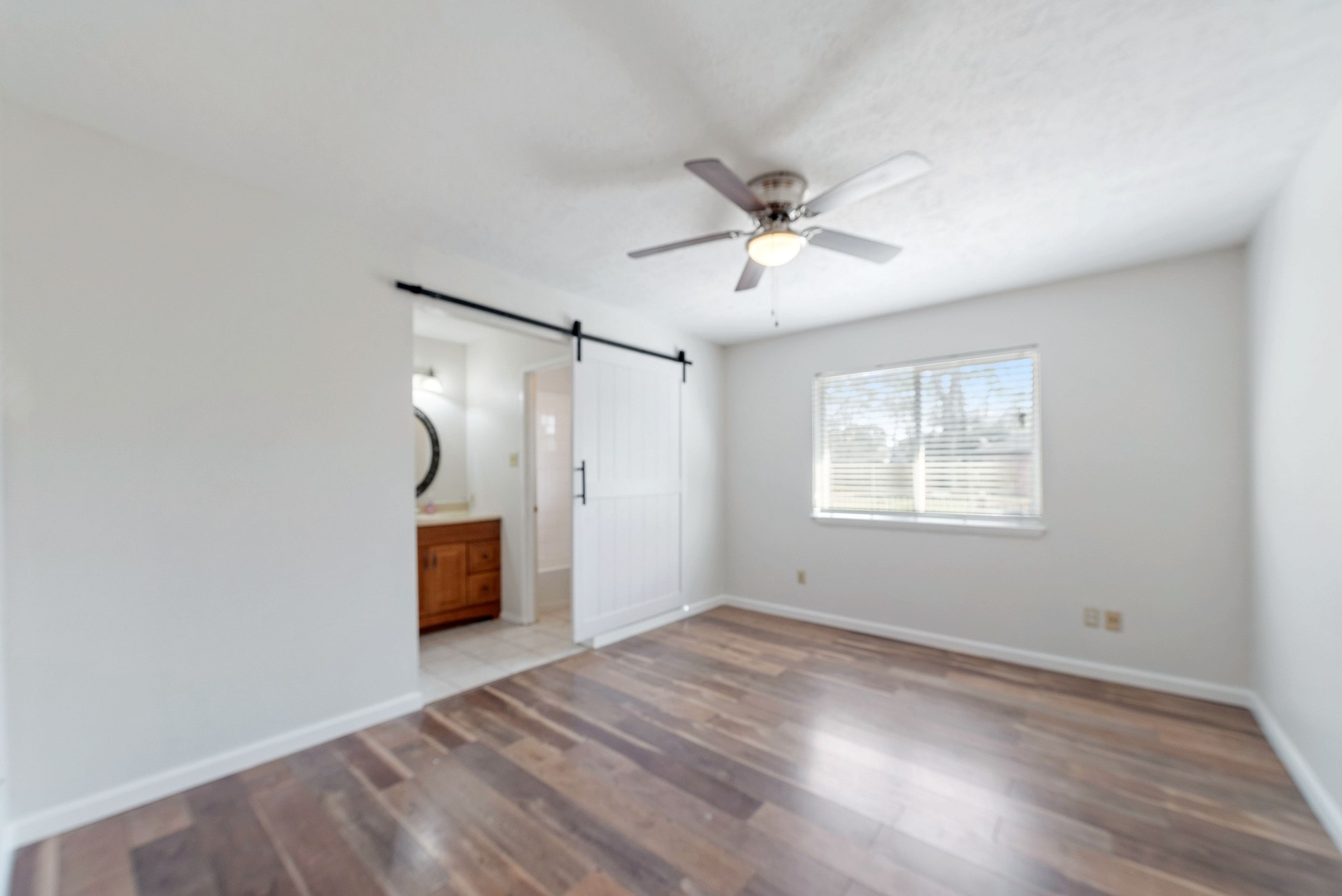 9622 Birsay Street Spring, TX 77379 - Photo 10 of 17 Primary bedroom has ensuite bath and wood floors.