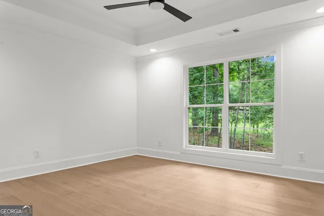 a front view of a house with a garden and yard