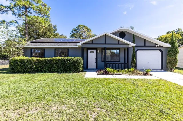 a front view of a house with a garden and yard