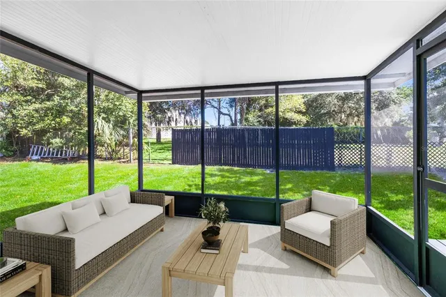 a view of a patio with couches and a big yard