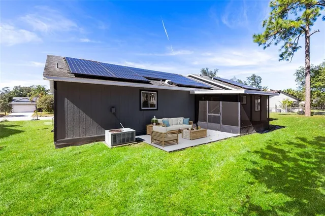 a front view of house with yard and outdoor seating