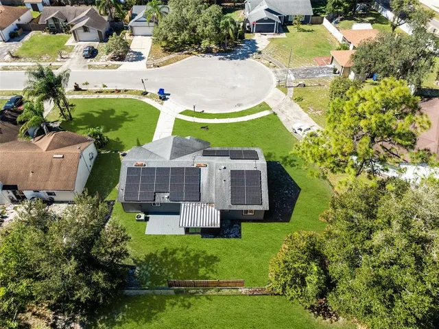 an aerial view of a house with a garden and swimming pool