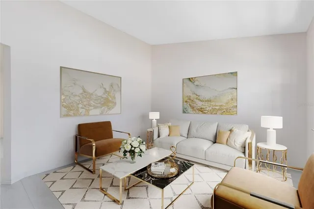 a living room with furniture and a painting on the wall