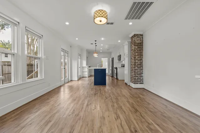 a view of a room with wooden floor