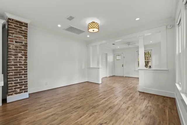 wooden floor in an empty room with a window