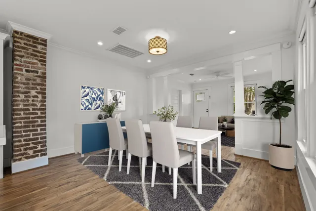 a view of a dining room with furniture and a potted plant
