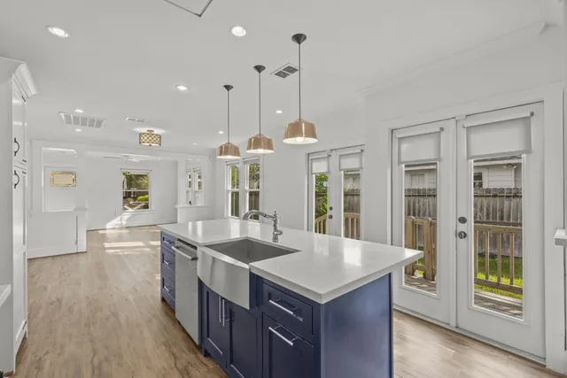 a kitchen with counter top space and wooden floor