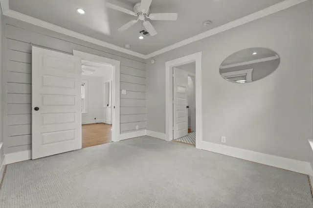 an empty room with closet and mirrors