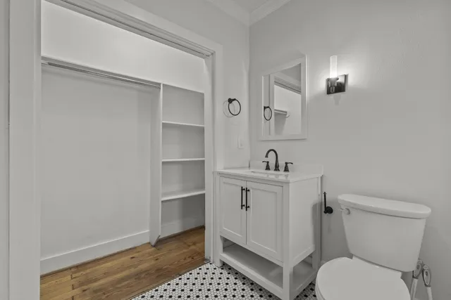 a bathroom with a toilet a sink and mirror