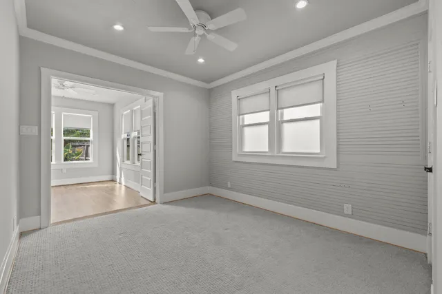 an empty room with windows and closet