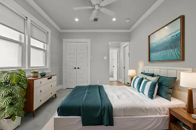 a spacious bedroom with a bed and a couch