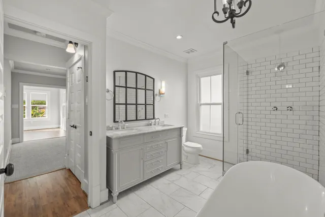 a bathroom with a tub sink and mirror