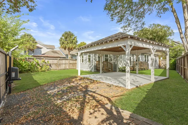 a view of a house with backyard and porch