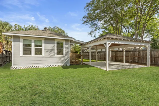 a view of a house with a yard and sitting area