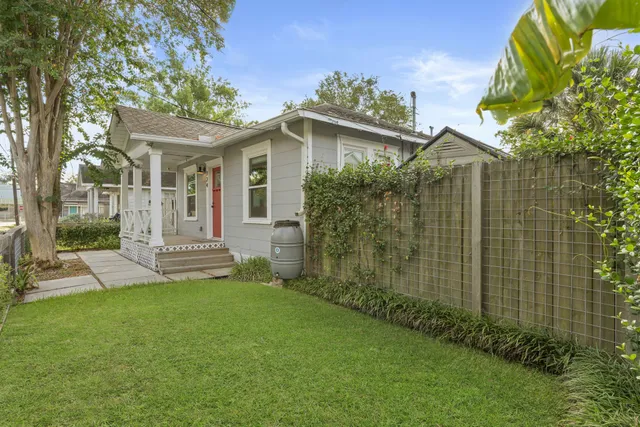 a view of a house with a yard and sitting area