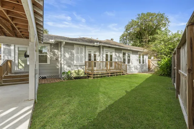 a view of a house with a yard and garden