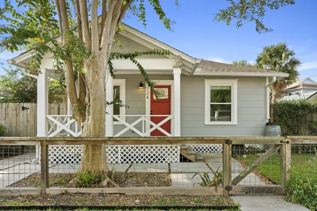 front view of a brick house with large windows