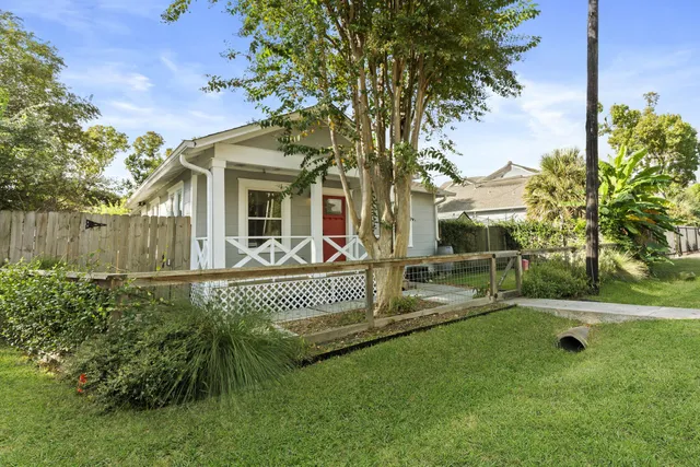 a view of house with a backyard