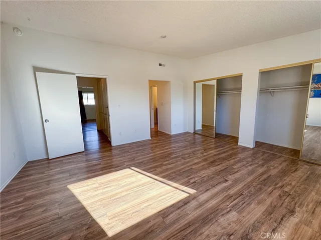 a view of a room with wooden floor and bathroom