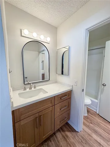 a bathroom with double vanity sink and two mirror