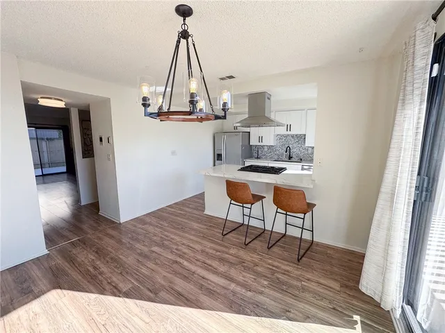 a view of a workspace with furniture and wooden floor