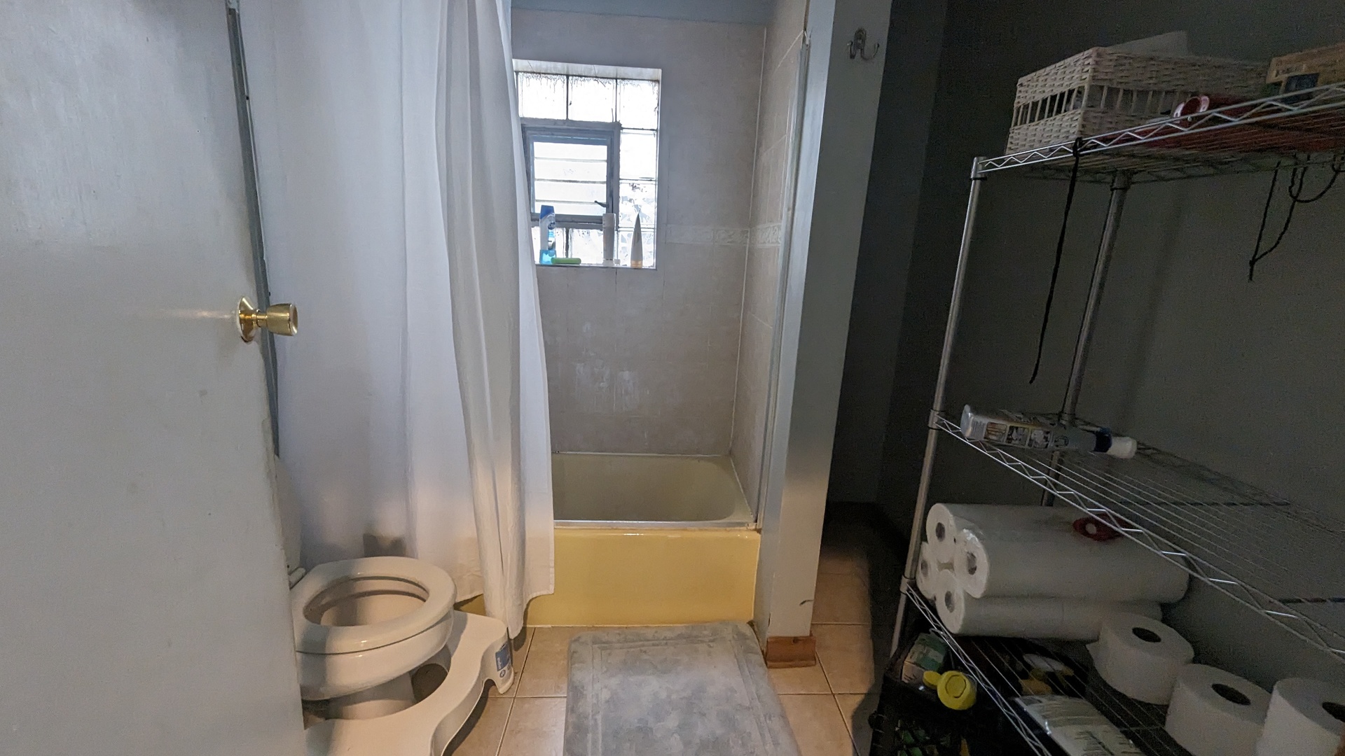 3922 North Bernard Street Chicago, IL 60618 - Photo 6 of 9 a bathroom with a window a bathtub and shower