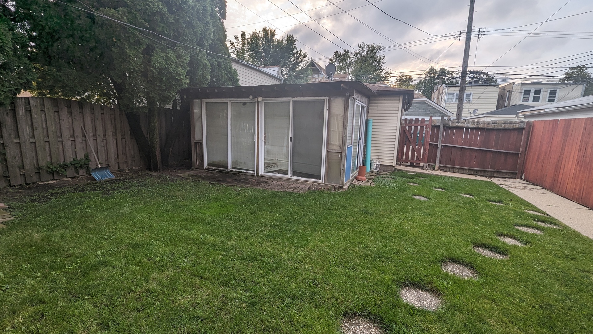 3922 North Bernard Street Chicago, IL 60618 - Photo 8 of 9 a view of a backyard with potted plants and wooden fence