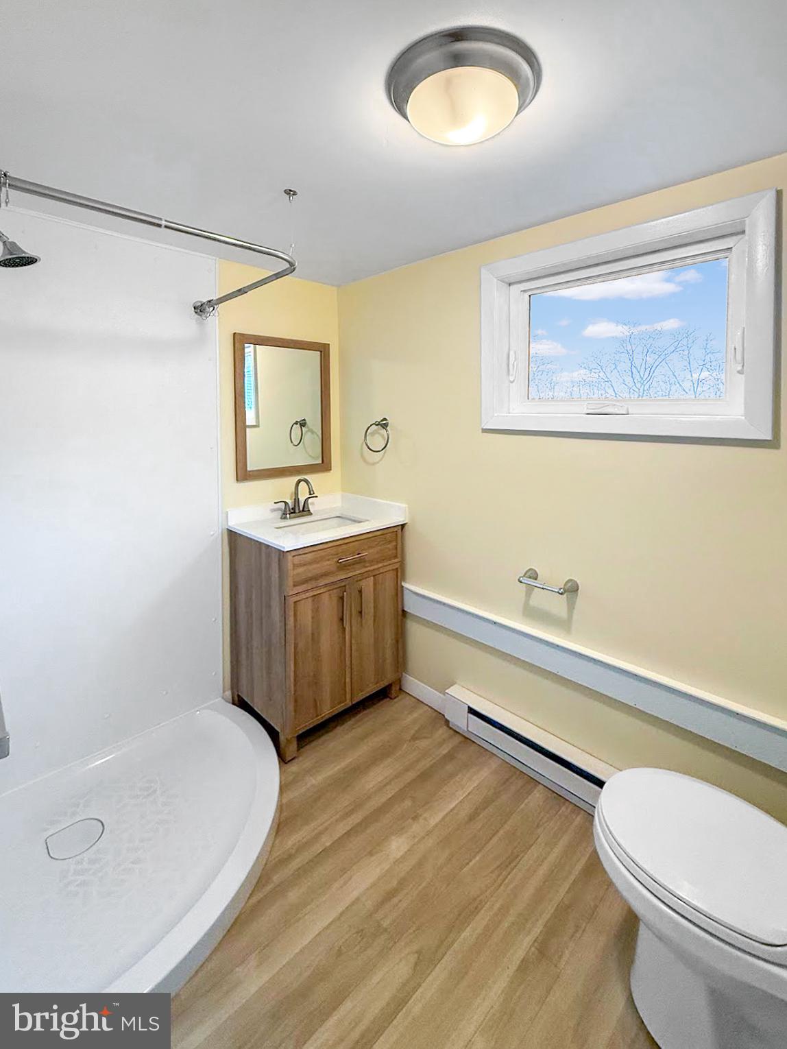 638 State Street Philipsburg, PA 16866 - Photo 7 of 11 a bathroom with a toilet a sink and mirror