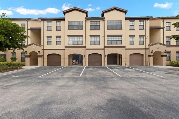 a front view of a residential apartment building with a yard