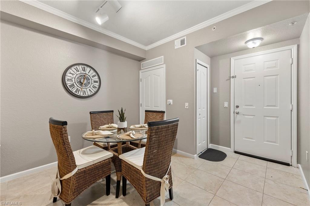 12955 Positano Circle, Unit 104 Naples, FL 34105 - Photo 11 of 40 a view of a room with furniture and a table