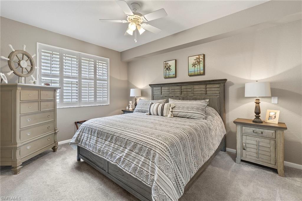 12955 Positano Circle, Unit 104 Naples, FL 34105 - Photo 17 of 40 a bedroom with a bed and a window