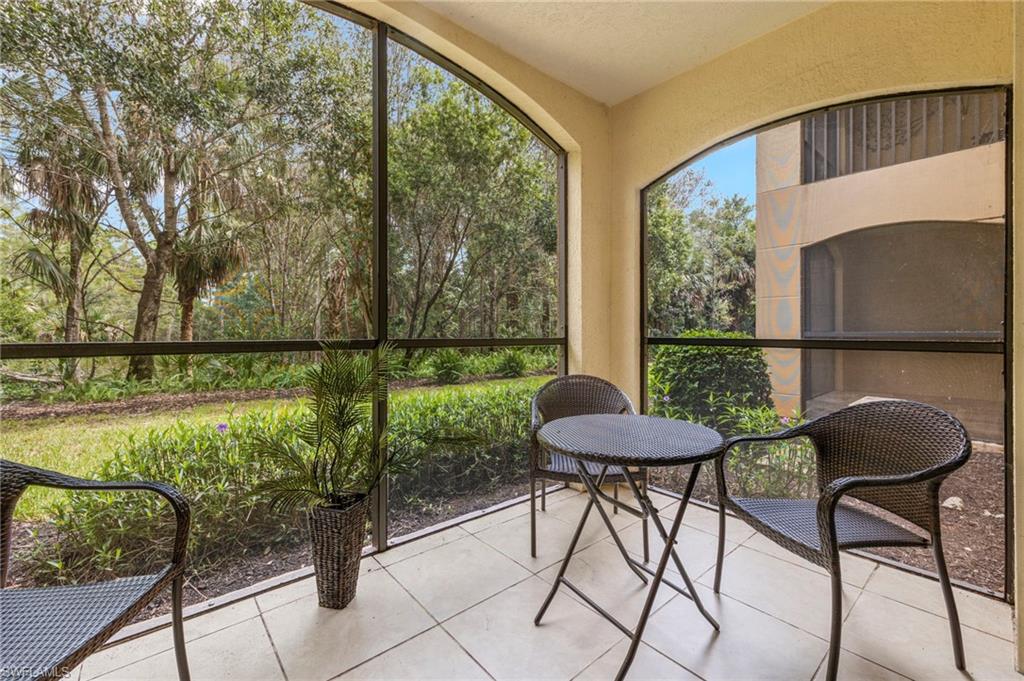 12955 Positano Circle, Unit 104 Naples, FL 34105 - Photo 21 of 40 a view of a chairs and table in the patio