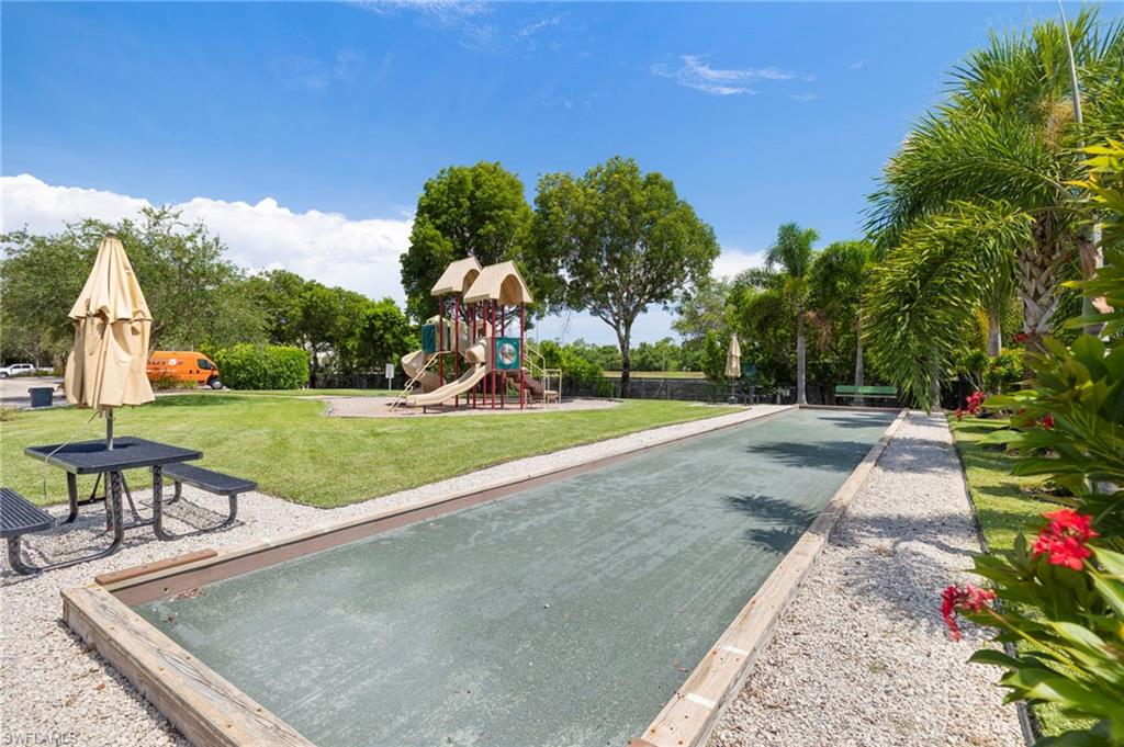 12955 Positano Circle, Unit 104 Naples, FL 34105 - Photo 23 of 40 a view of a backyard with a garden