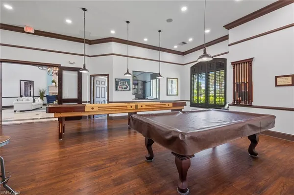 a living room with furniture pool table and a large window