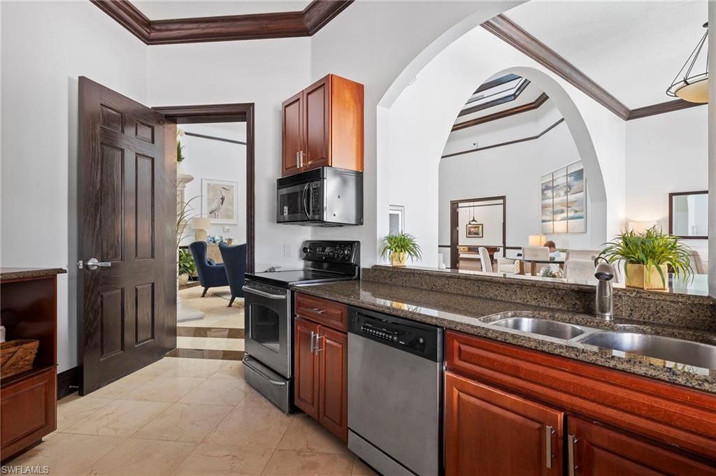12955 Positano Circle, Unit 104 Naples, FL 34105 - Photo 30 of 40 a kitchen with stainless steel appliances a sink stove and cabinets